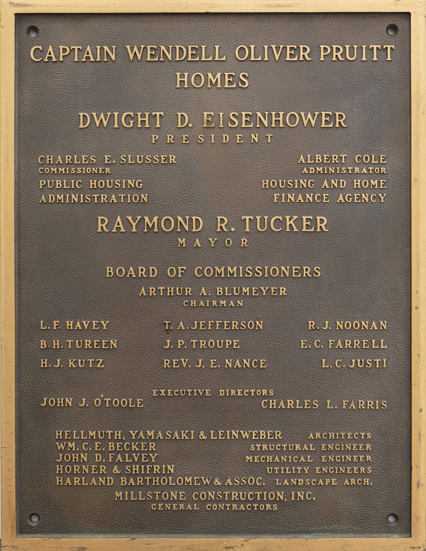 Bronze dedication plaque for the Captain Wendell Oliver Pruitt Homes, listing federal and city officials, the architects and the builders